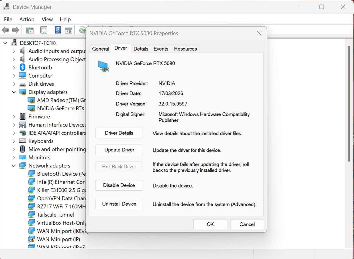 Device Manager with a display adapter's Properties open on the Driver tab, showing the Roll Back Driver button used to return to the pre-update driver version (greyed out when no previous driver is stored).