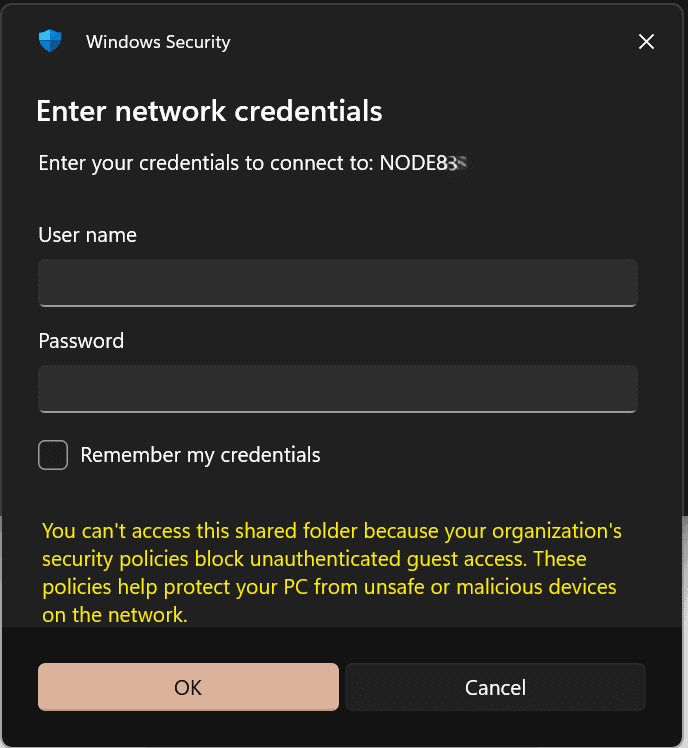 The Windows Security 'Enter network credentials' dialog with the yellow message that you can't access this shared folder because your organization's security policies block unauthenticated guest access.